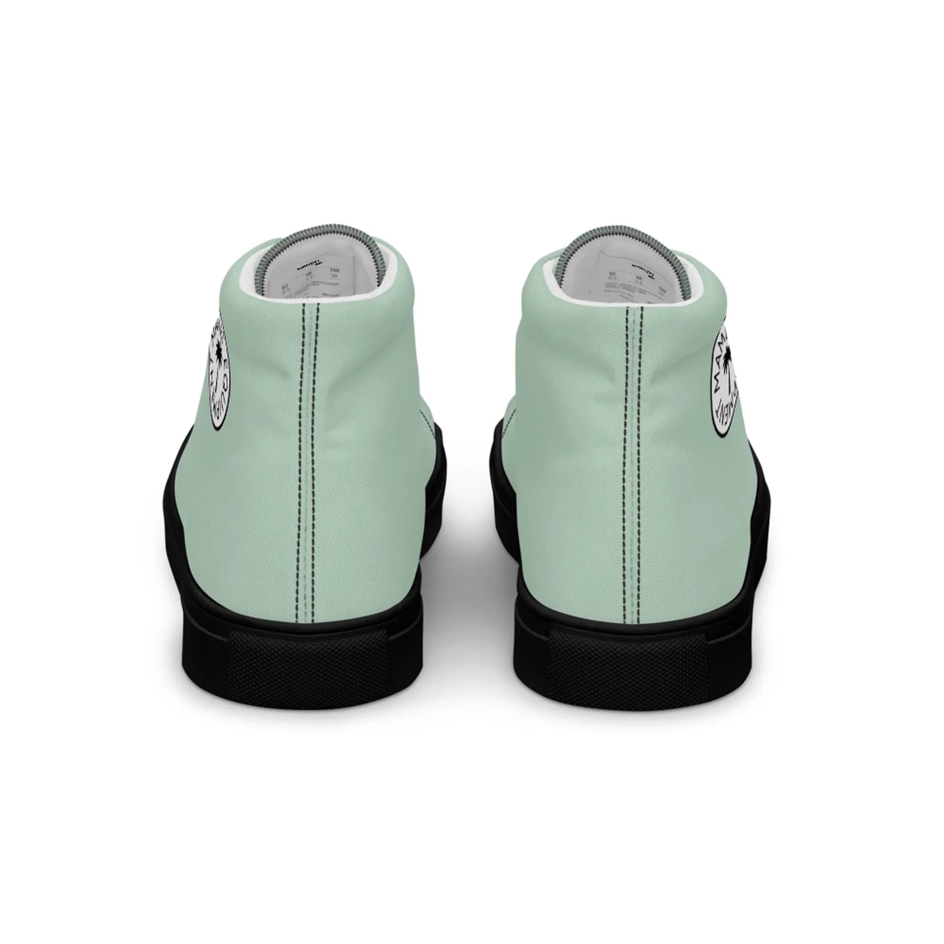 A pair of mint green Mambí high-top sneakers with black soles, shown from the back. Each shoe features a circular white and black logo near the heel.