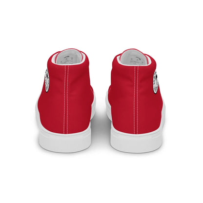 A pair of red high-top sneakers viewed from the back, featuring white soles, a black circular logo on the outer side of each shoe, and subtle Mambí accents.