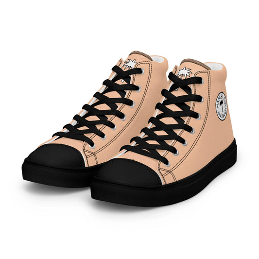 The Carlito Sastre Vintage Hi-Top Sneakers by Printful feature a beige canvas upper, black laces, toe caps, and soles, with a circular side logo and palm tree detail on the tongue. Womens sizes in Black/Peach.