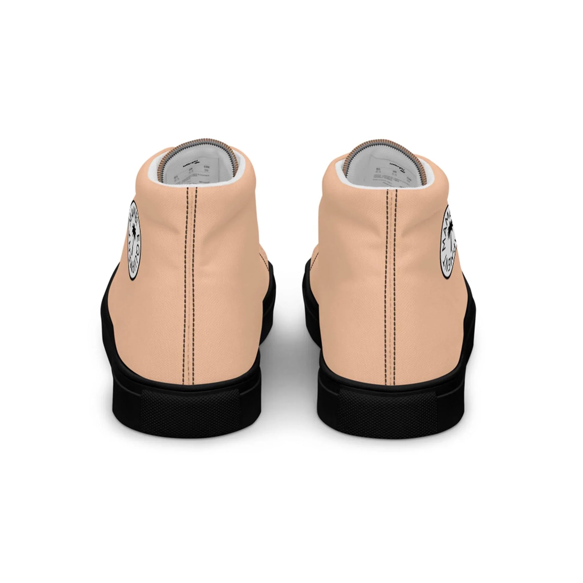 The Printful Carlito Sastre Vintage Hi-Top Sneakers for women feature a light peach canvas, black soles, a black-and-white circular heel logo, and light gray lining—blending classic style with modern comfort.
