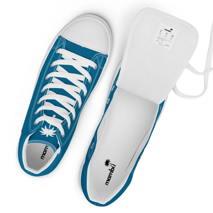 Top view of a pair of blue and white sneakers with white laces. One shoe displays the insoles and the Mambí logo with a palm tree, while the other has its tongue lifted, revealing a white label inside.