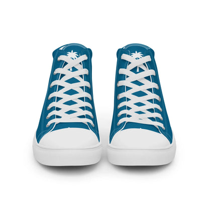 A pair of blue high-top sneakers with white laces and soles, shown from the front. Each shoe features a white palm tree graphic on the tongue, adding a Mambí-inspired touch.