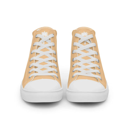 A pair of light tan Mambí high-top sneakers with white soles, toe caps, and laces, viewed from the front; each shoe features a small white palm tree design on the tongue.