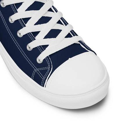 The Carlito Sastre Vintage Hi-Top Sneakers for women by Printful feature white/navy canvas, white laces, crisp white stitching, and a classic white rubber sole.