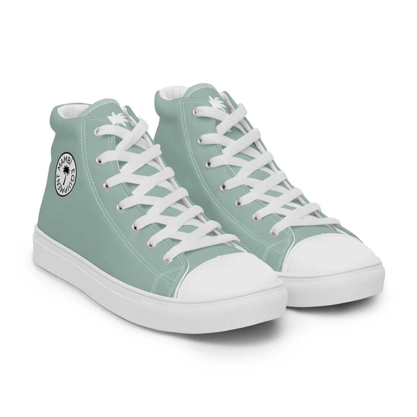 A pair of light teal Mambí high-top sneakers with white laces, white soles, and a circular black and white logo on the ankle area.