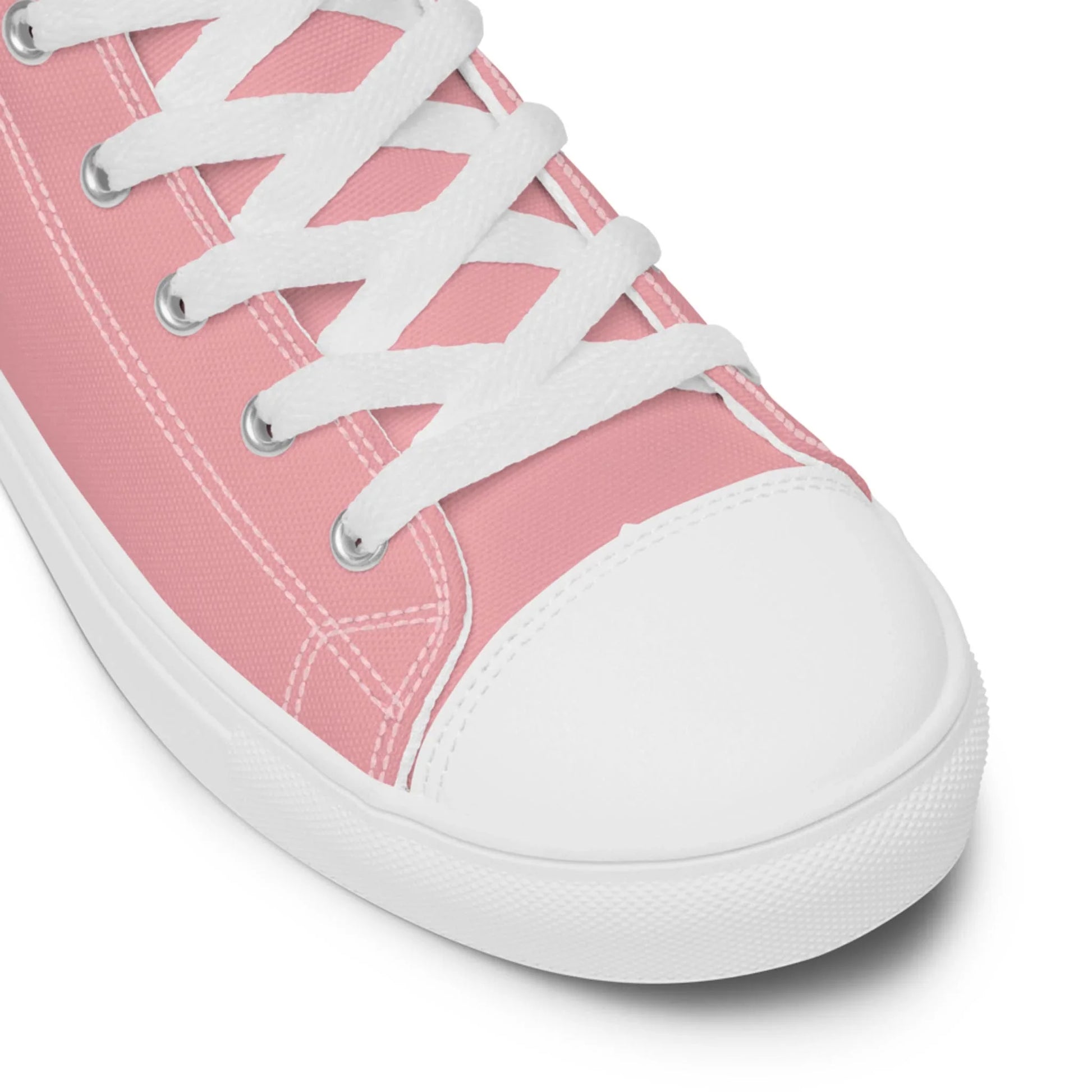 Close-up of the Carlito Sastre Vintage Hi-Top Sneakers for women by Printful in White/Pink, featuring white laces, stitching, and a rubber toe cap and sole, shown against a plain white background.