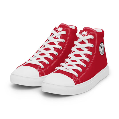 A pair of red high-top Mambí sneakers with white laces, white soles, and a black circular logo featuring a palm tree and text. The shoes are positioned side by side on a white background.