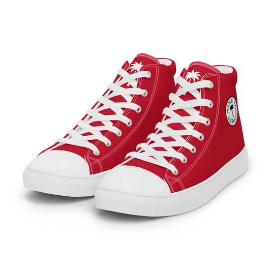 A pair of red high-top Mambí sneakers with white laces, white soles, and a black circular logo featuring a palm tree and text. The shoes are positioned side by side on a white background.