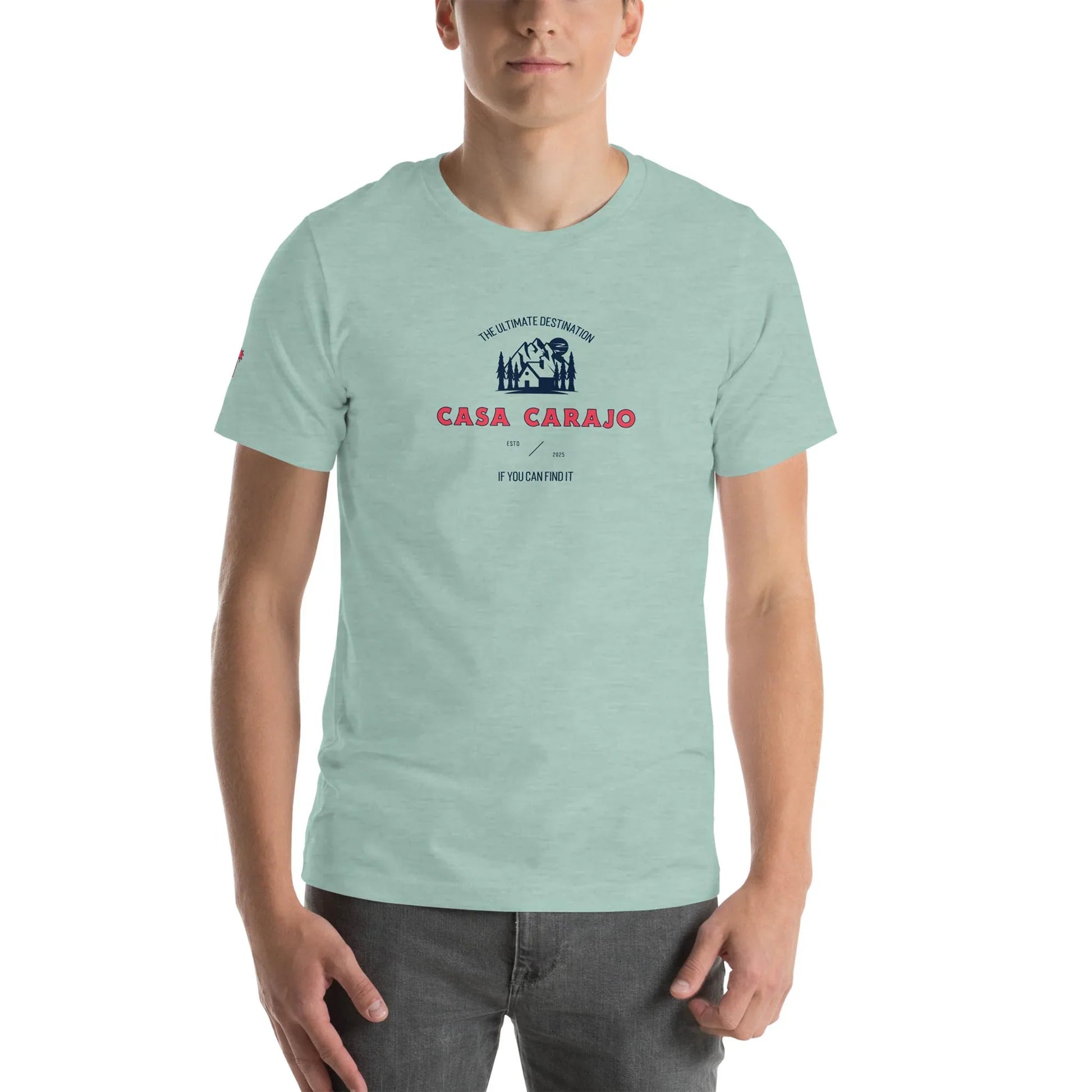 A person wearing a light green t-shirt with Casa Carajo in red and a dark blue Mambí graphic above it, plus smaller black and red text below, standing against a plain white background.