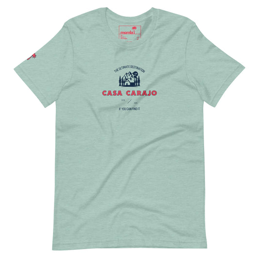 Light green Mambí T-shirt featuring a dark blue and red graphic with “Casa Carajo” text, smaller lettering above and below, and a small palm tree logo on the left sleeve.