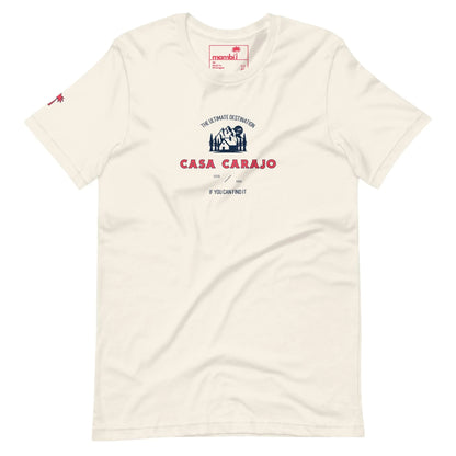 Off-white t-shirt featuring a small red palm tree on the left sleeve and a central graphic with a blue and red house illustration, reading Casa Carajo and If you cant find it, you cant do it—celebrating Mambí spirit.