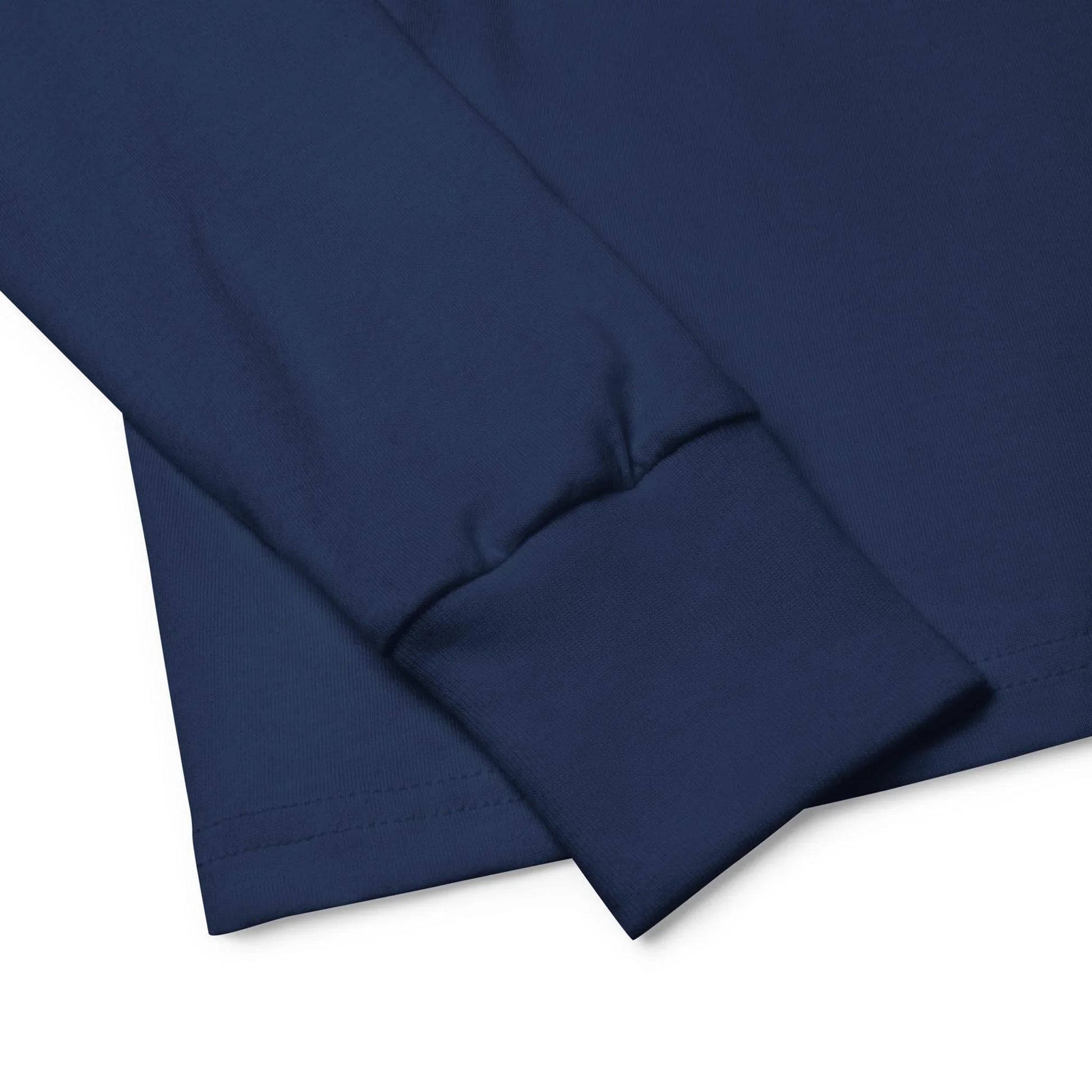 Close-up of the cuff and sleeve of a navy blue Mambí long-sleeve shirt, highlighting the neatly stitched hem and smooth cotton fabric.