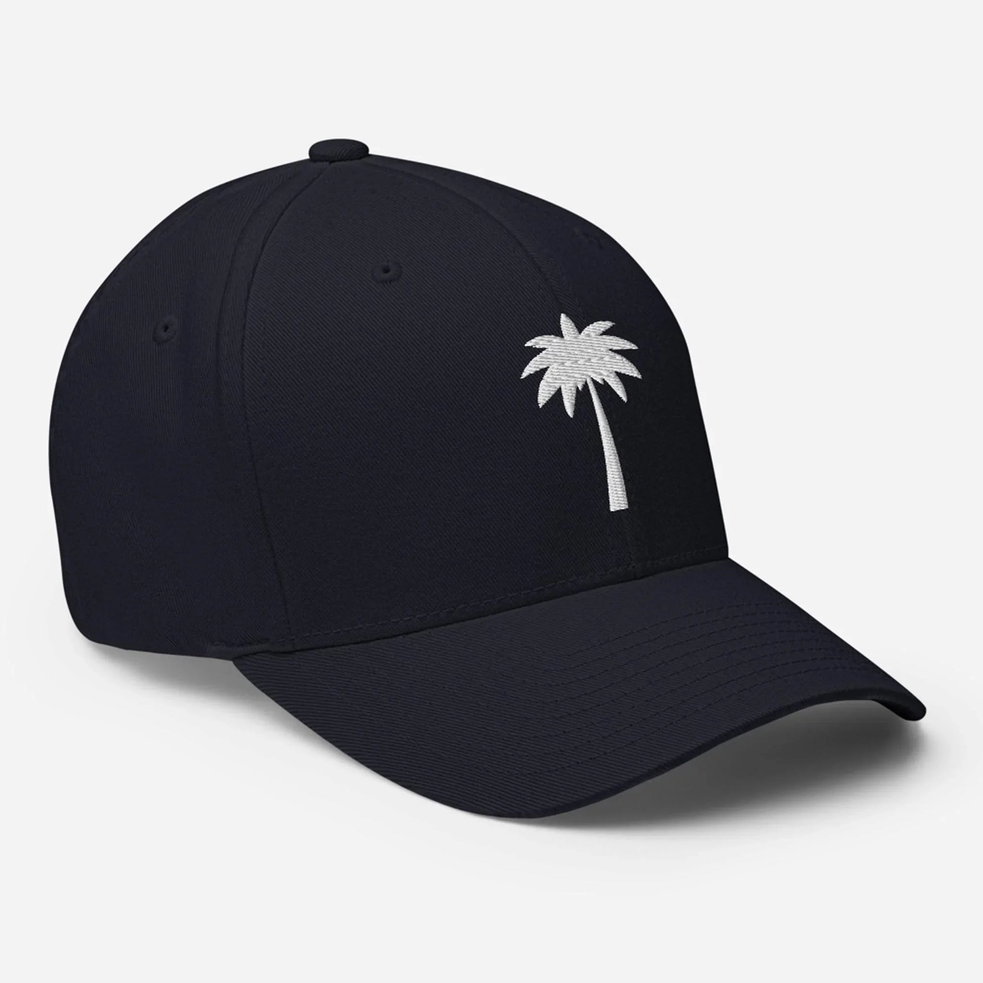 A black Mambí baseball cap featuring a small white embroidered palm tree design on the front, photographed against a plain white background.