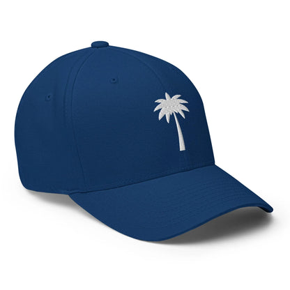 A blue baseball cap featuring a simple white embroidered palm tree design on the front left panel, inspired by Mambí style.