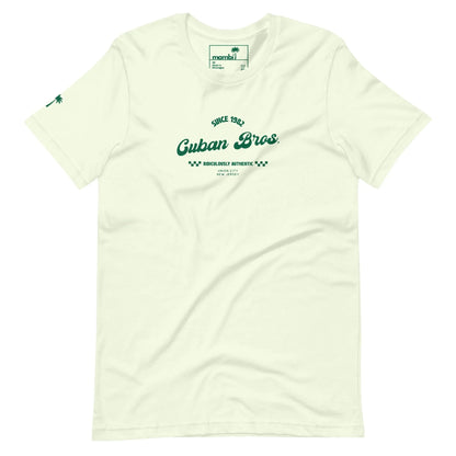 Printfuls Cuban Bros Graphic Tee | Unisex: Off-white with vintage green text—Since 1992, Cuban Bros, Brooklyn’s Authentic NYC—and a palm tree sleeve detail. Part of the Neighborhood Collection. Tag inside collar reads momini. Relaxed, entrepreneurial style.