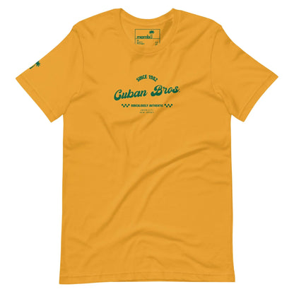 The Cuban Bros Graphic Tee by Printful is a unisex yellow shirt with green ‘Since 1982 Cuban Bros. Brooklyn, Authentic’ chest text and a palm tree graphic on the sleeve—ideal for entrepreneurs with laid-back style.
