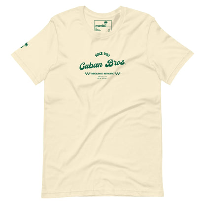 The Cuban Bros Graphic Tee | Unisex by Printful is an off-white t-shirt from the Neighborhood Collection with green Since 1982 Cuban Bros. Brooklyn’s Authentic New York text on the chest and a small palm tree logo on the left sleeve.