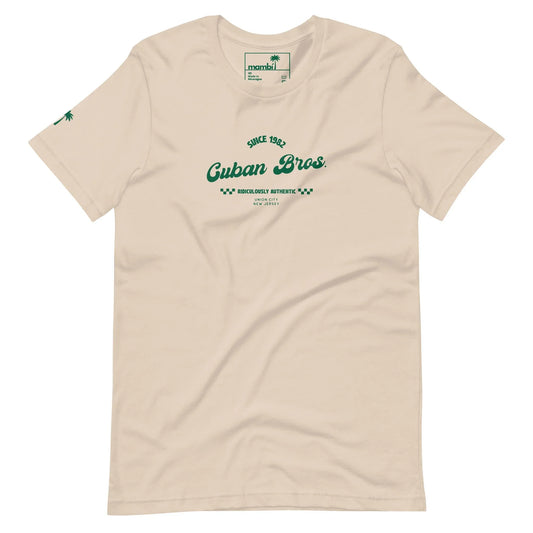 Printfuls unisex Cuban Bros Graphic Tee from the Neighborhood Collection features beige fabric, green “Since 1992 Cuban Bros. Brooklyns Authentic, New York City” chest text, and a small green palm tree on one sleeve—ideal for stylish entrepreneurs.