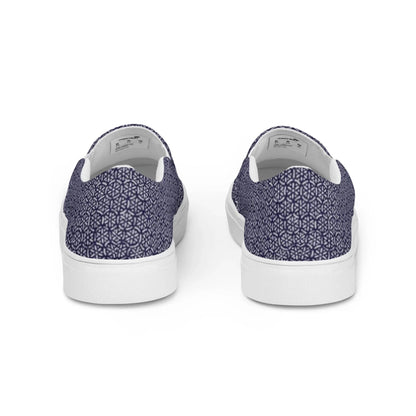 The Digno Handmade Slip-On Canvas Shoes for men by Printful showcase a geometric navy blue and white pattern with white rubber soles, viewed from the back—perfect for making a bold fashion statement.