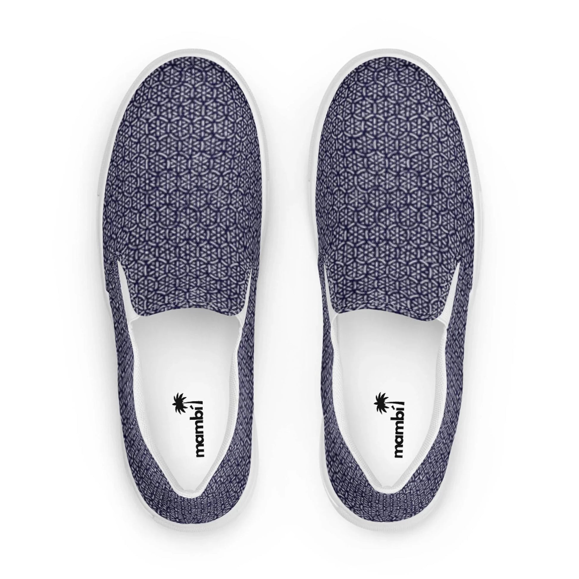 The Digno Handmade Slip-On Canvas Shoes for men by Printful feature a dark blue geometric pattern on canvas, white soles, and insoles branded with a black palm tree logo and mambil. Viewed from above.