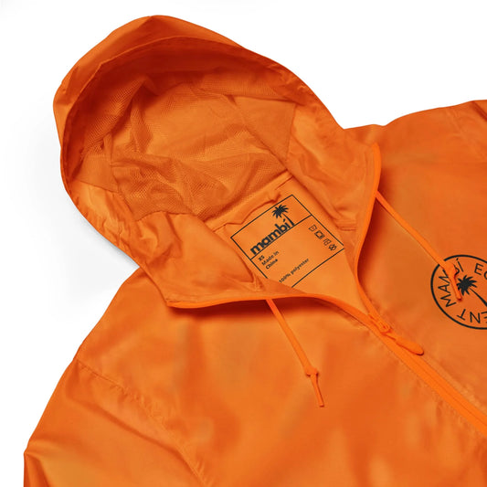 Bright orange hooded jacket with a drawstring, featuring a black circular logo and the brand name Mambí on the chest, plus an inner label with product details.