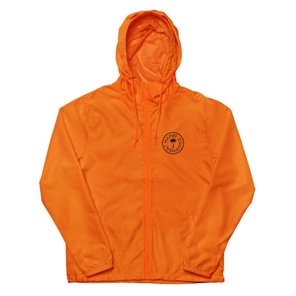 Bright orange Mambí hooded jacket with front zipper, drawstrings, and a circular black logo on the left chest. Featuring long sleeves, this lightweight jacket is ideal for casual wear or outdoor activities.