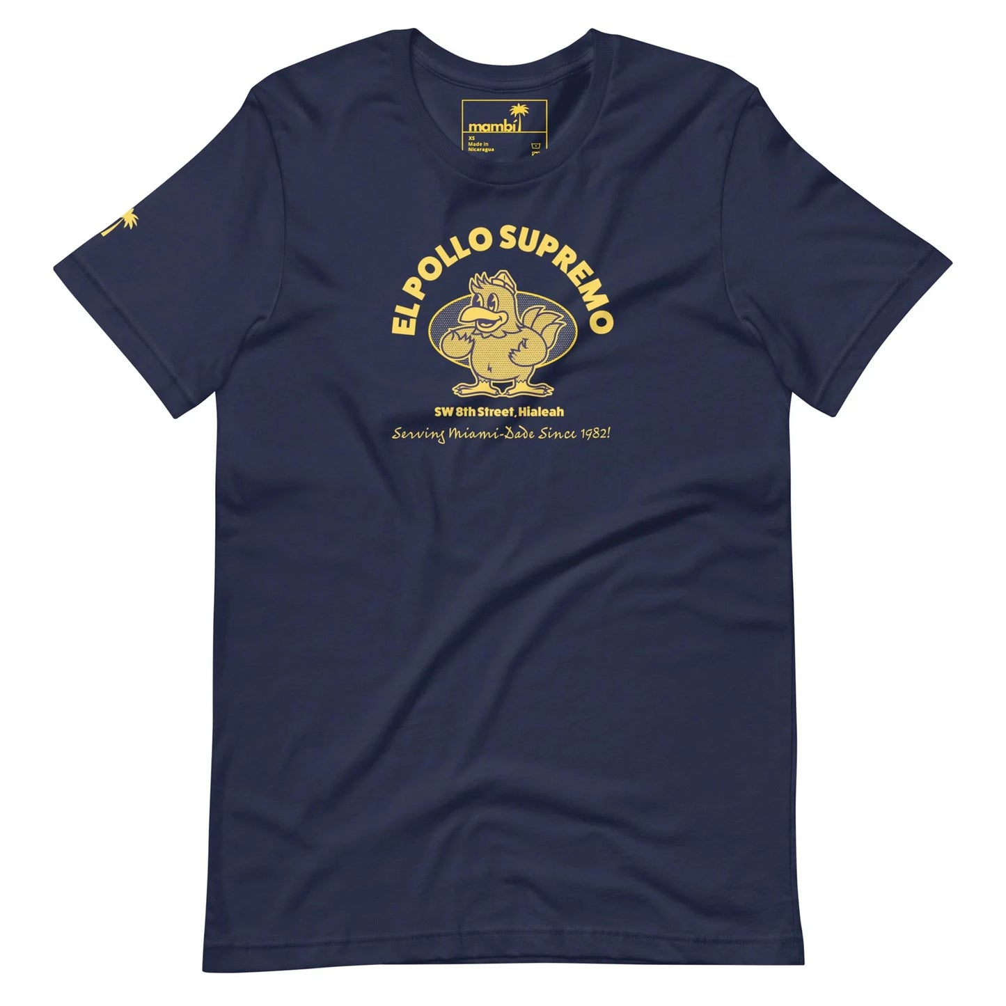 Navy blue t-shirt featuring a yellow cartoon chicken flexing its arm, with the text EL POLLO SUPREMO, address details, and the phrase Serving Home-Style Since 1982. Inspired by Mambí flair.
