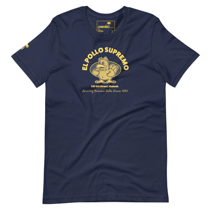 Navy blue t-shirt featuring a yellow cartoon chicken flexing its arm, with the text EL POLLO SUPREMO, address details, and the phrase Serving Home-Style Since 1982. Inspired by Mambí flair.