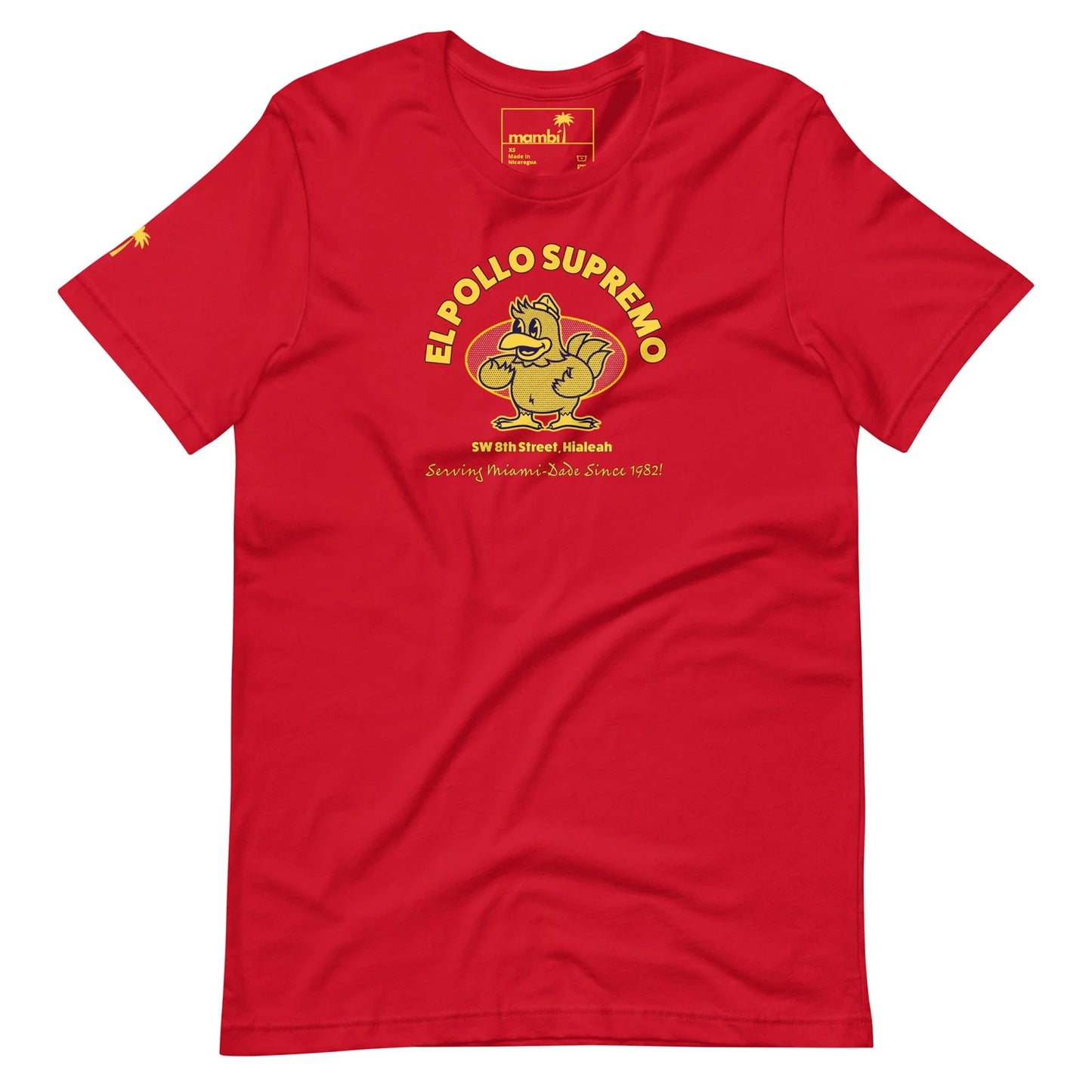 A red T-shirt featuring a cartoon chicken mascot, yellow Mambí text reading EL POLLO SUPREMO, and smaller text below with an address and Serving Hialeahs Best Since 1982.