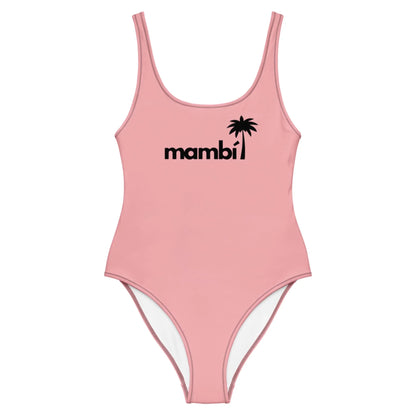 A light pink one-piece swimsuit featuring Mambí and a black palm tree graphic on the chest, with a scoop neckline and high-cut legs.