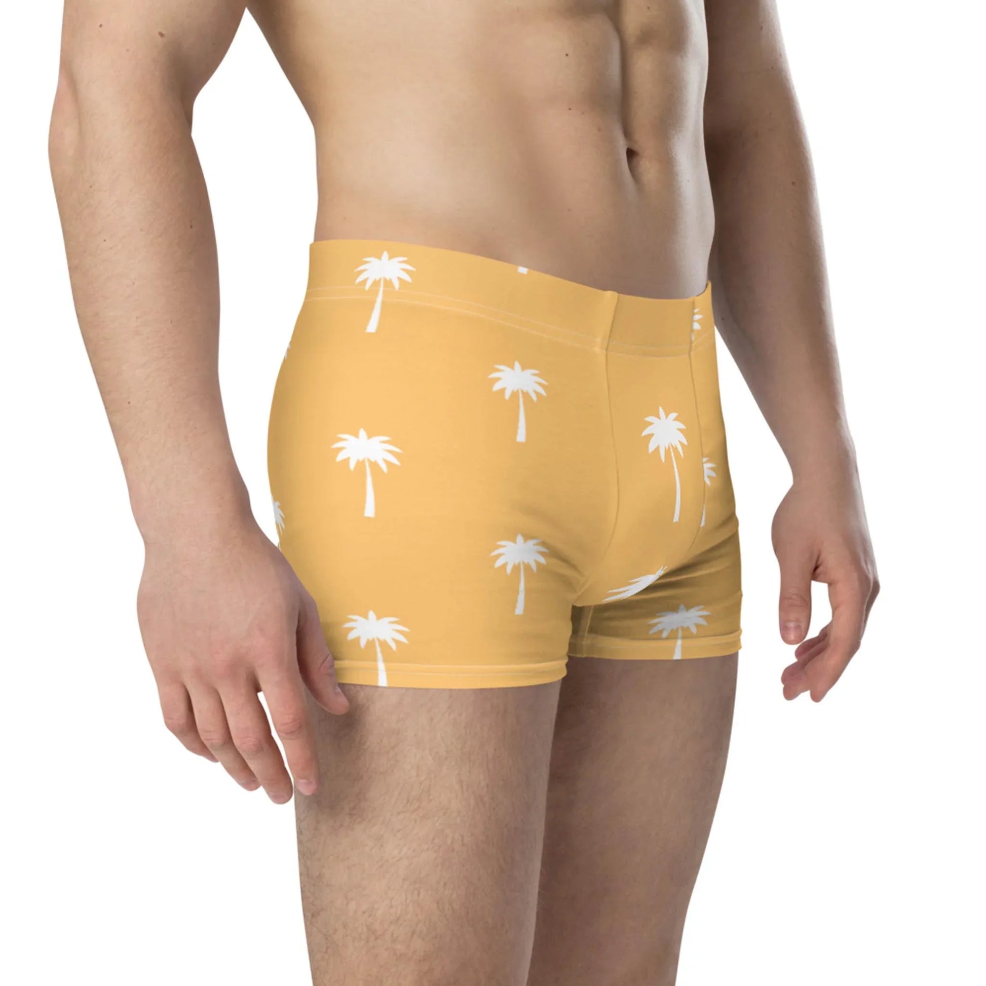 A man models the Printful Emerson Boxer Brief for men, featuring a white palm tree pattern and a seamless no-back-seam design, shown waist to mid-thigh against a plain white background.