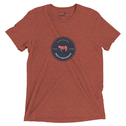 A heathered rust-colored Mambí t-shirt with a circular navy logo in the center featuring a cow illustration and the text ESPINOSA BEEF & PROVISIONS, along with Texas Born and Family Raised.