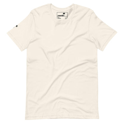 Off-white short-sleeve t-shirt with a small black Mambí logo tag on the collar and a tiny black palm tree icon on the left sleeve. The shirt is plain, featuring no other visible designs or patterns.