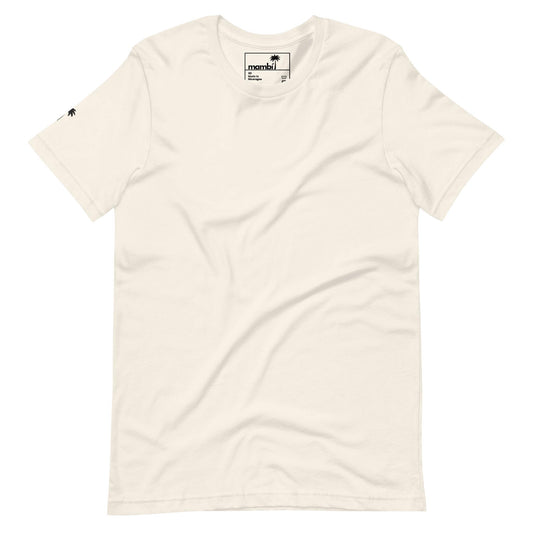 Off-white short-sleeve t-shirt with a small black Mambí logo tag on the collar and a tiny black palm tree icon on the left sleeve. The shirt is plain, featuring no other visible designs or patterns.