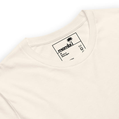 A close-up of the neck and collar area of a white t-shirt. The tag inside the shirt displays the Mambí brand with a small palm tree graphic and sizing details printed in black.