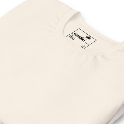 A close-up of a folded off-white crew neck t-shirt showcases the collar and inside label with the brand name “Arambi,” a small palm tree logo, and a subtle nod to Mambí style.