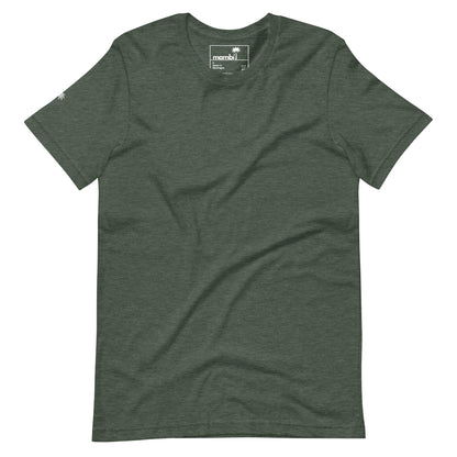 A plain dark green short-sleeve t-shirt lies flat, featuring a small Mambí logo on the neck tag and a tiny design on the left sleeve. The shirt has a soft, slightly heathered texture.