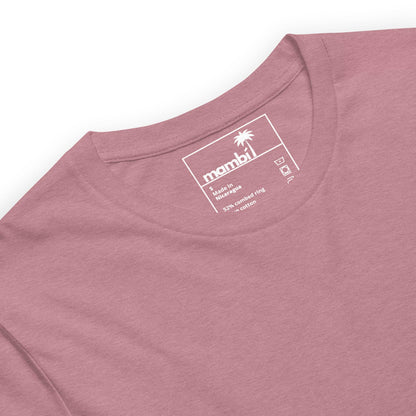 A close-up of a dusty pink t-shirt with a round neckline. The inner label displays the Mambí brand with a palm tree logo, size L, and fabric details: 52% combed cotton, 48% polyester.