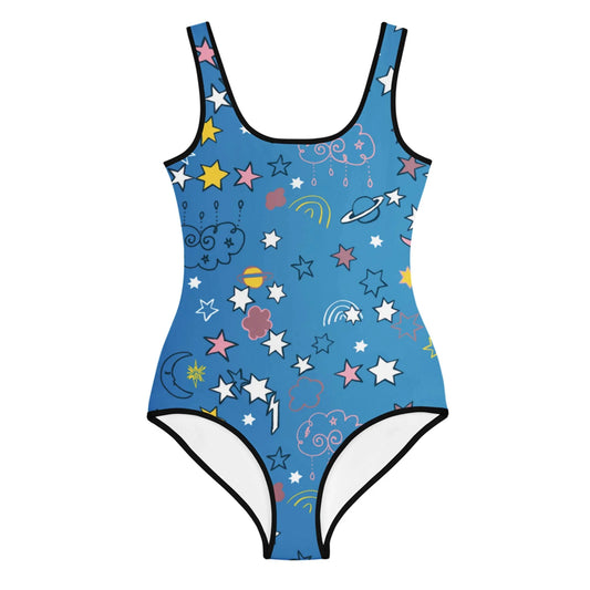 Blue one-piece swimsuit by Mambí with black trim, featuring a playful pattern of stars, clouds, planets, rainbows, and lightning bolts in pink, yellow, white, and blue.