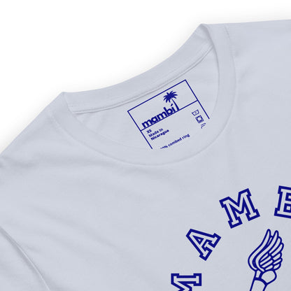 Close-up of a white t-shirt with a blue printed label inside the neck reading Mambí, size M, and Made in Nicaragua. Part of a blue winged logo and lettering are visible on the front.