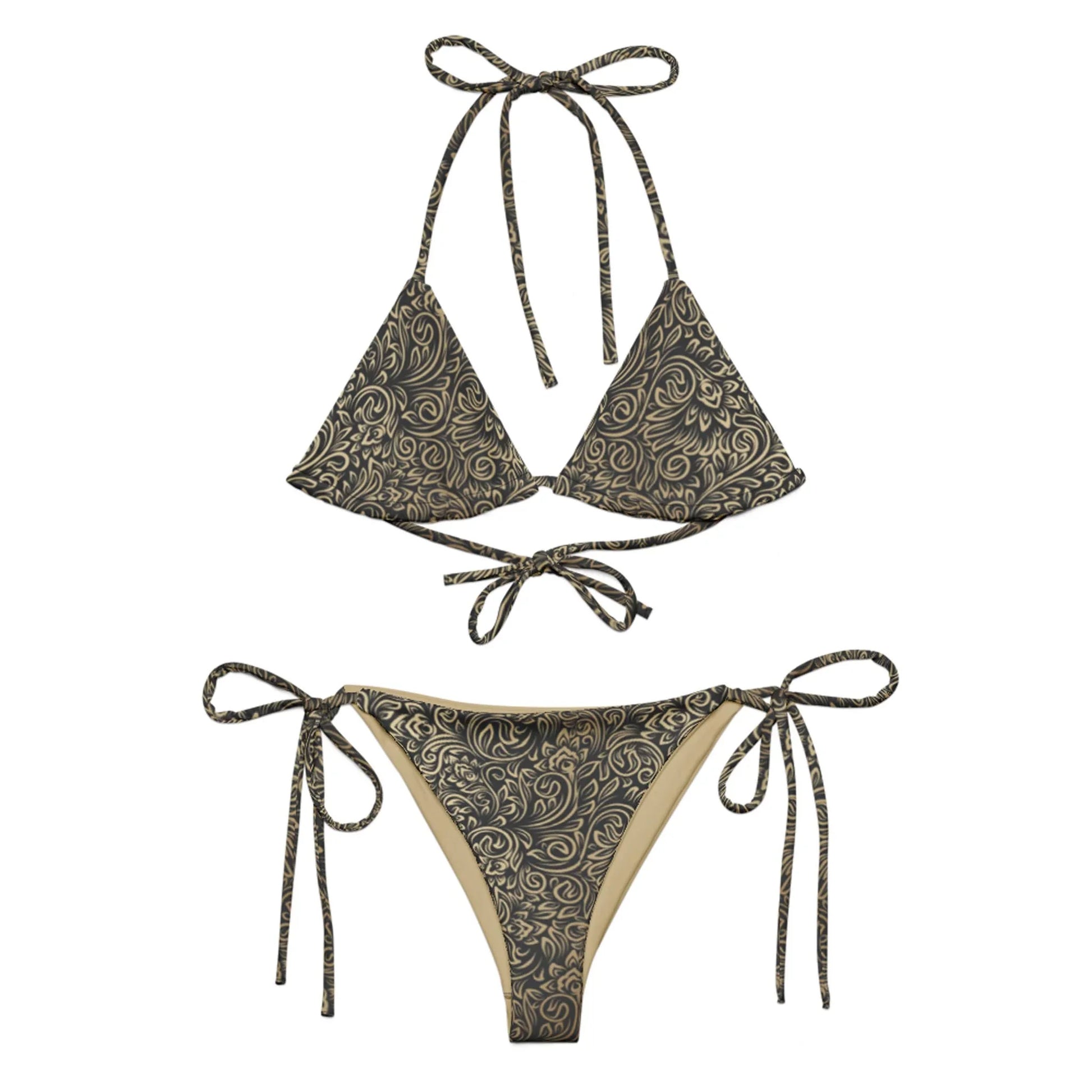 The Flavia String Bikini Swimsuit by Printful features a black and gold swirling floral pattern, triangle cups with ties, side-tie bottoms, recycled polyester fabric, and UPF 50+ sun protection.
