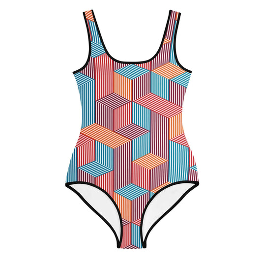One-piece Mambí swimsuit with a geometric pattern in red, orange, blue, and black, featuring interlocking striped shapes and black piping. The suit has a scoop neck and high-cut leg openings.