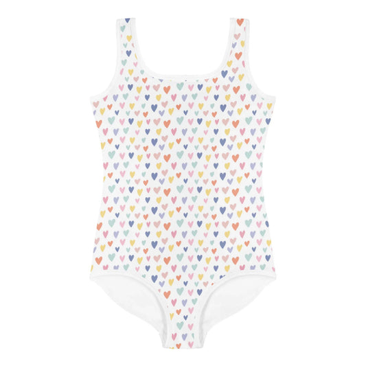 The Printful Gemma One-Piece Swimsuit for toddlers and little kids features a white, sleeveless design with rows of colorful hearts and offers UPF sun protection—ideal for stylish, safe fun in the sun.