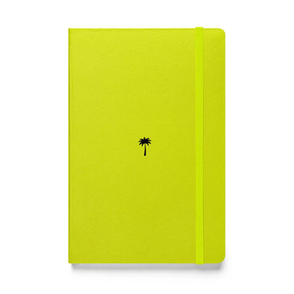 A bright yellow-green Mambí notebook with a small black palm tree icon centered on the cover. An elastic band for closure runs vertically along the right edge.