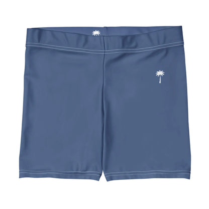 Blue swim trunks with white stitching, featuring a small white palm tree graphic on the left leg and a similar palm tree on the back waistband, inspired by Mambí style.