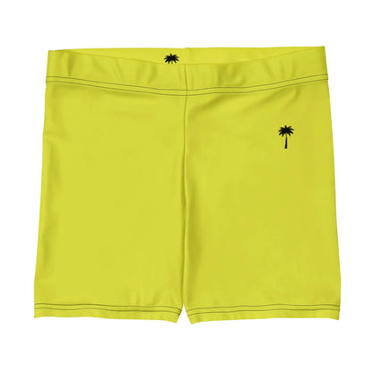 Bright yellow Mambí swim trunks feature a small black palm tree graphic near the left hip and another by the back waistband. Visible stitching accents the seams.