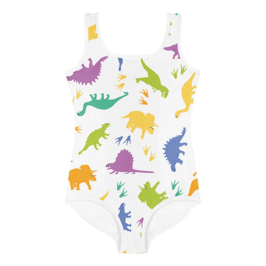 A white one-piece swimsuit by Mambí featuring a colorful dinosaur pattern with green, yellow, orange, blue, and purple dinosaurs and matching dinosaur footprints.