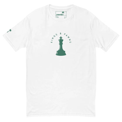 White t-shirt featuring a green chess king silhouette at the center with the text Kings & Pawns curved above it; a small green palm tree and subtle Mambí detail on the left sleeve.
