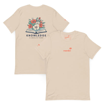 The Knowledge Graphic Tee by Printful is a beige unisex cotton shirt. The back has an open book with flowers and KNOWLEDGE IS ABSOLUTE POWER. The front features a small red mambi logo with a palm tree on the left chest.