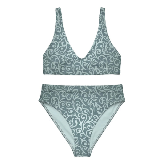The Laurelia High-Waisted Bikini Swimsuit for women by Printful is a muted teal set with a deep V-neck top, removable pads, and matching bottoms, both featuring an elegant light swirl and floral pattern.